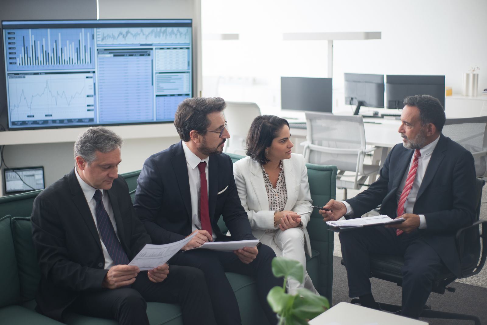 Business professionals discussing financial strategy in a modern office