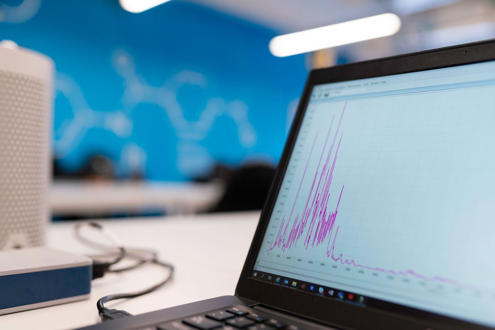 Laptop displaying a data analytics graph in a modern office