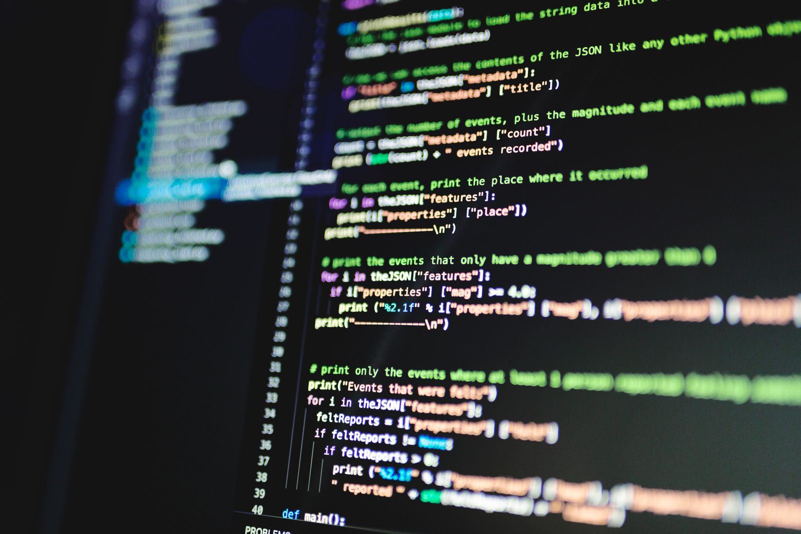 Close-up of programming code on a dark monitor